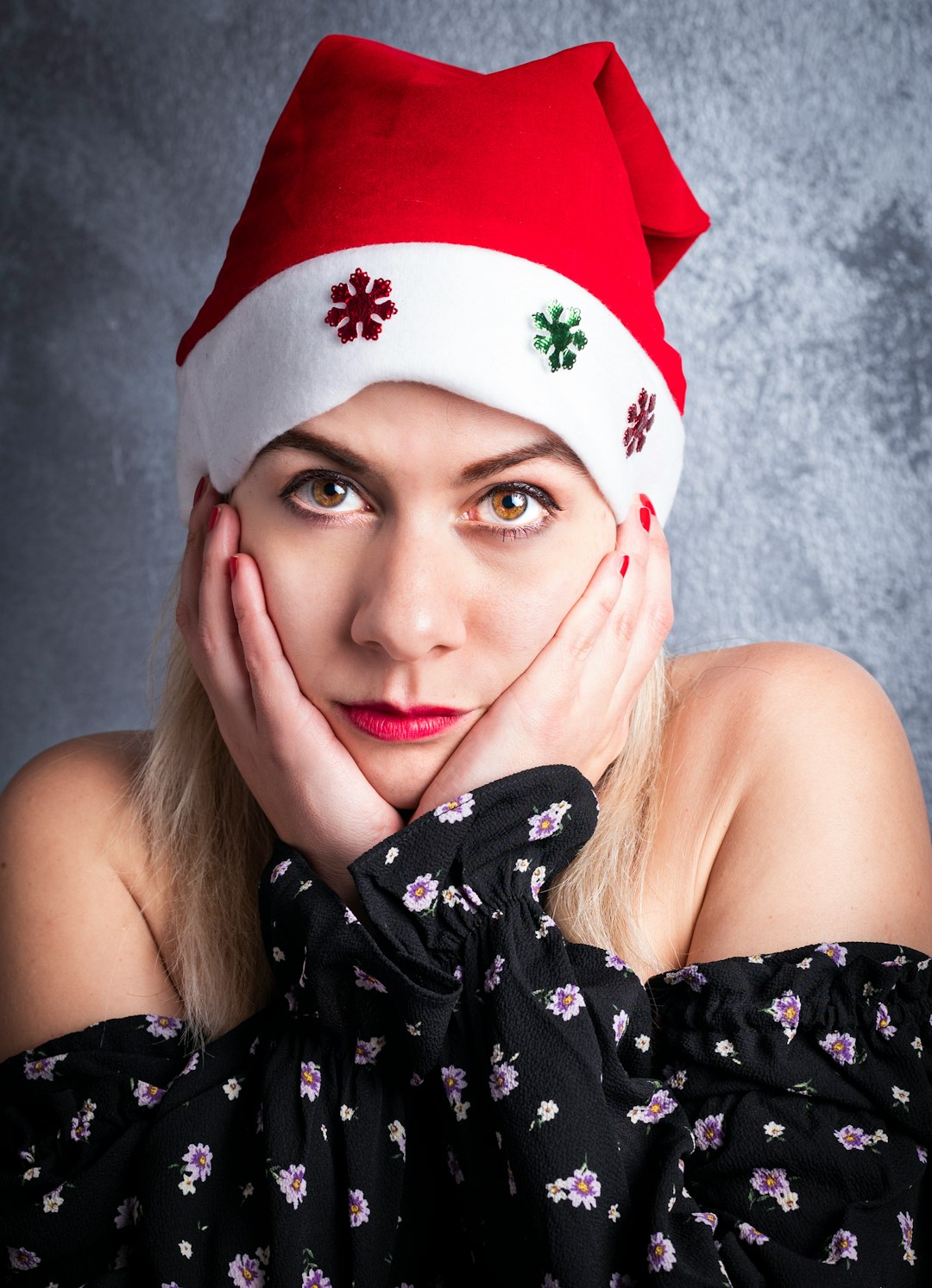 woman in black and white floral tube dress wearing red and white santa hat