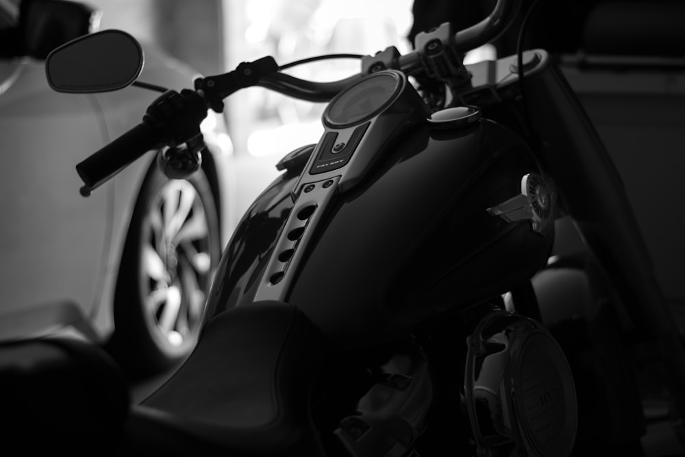 black motorcycle in grayscale photography