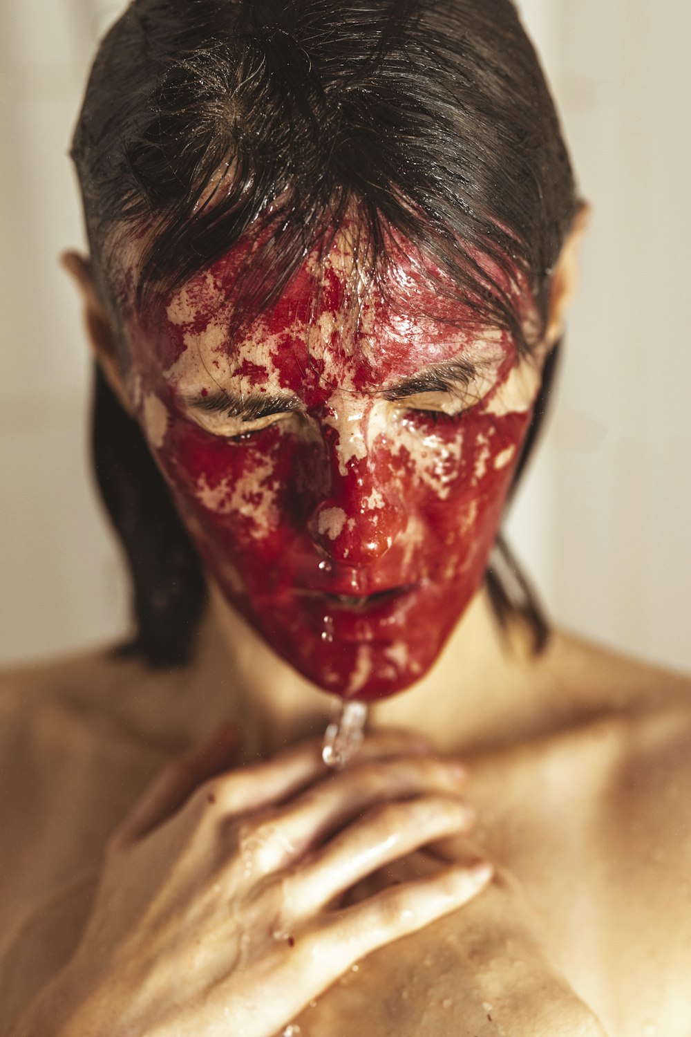 topless man with red paint on face