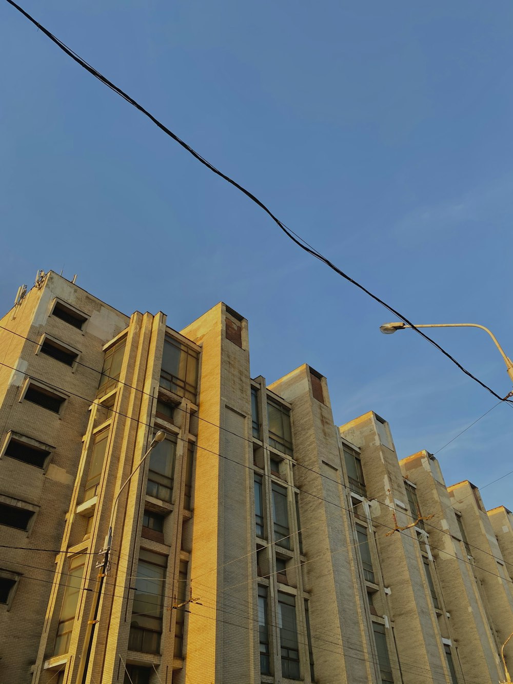 brown concrete building under blue sky during daytime