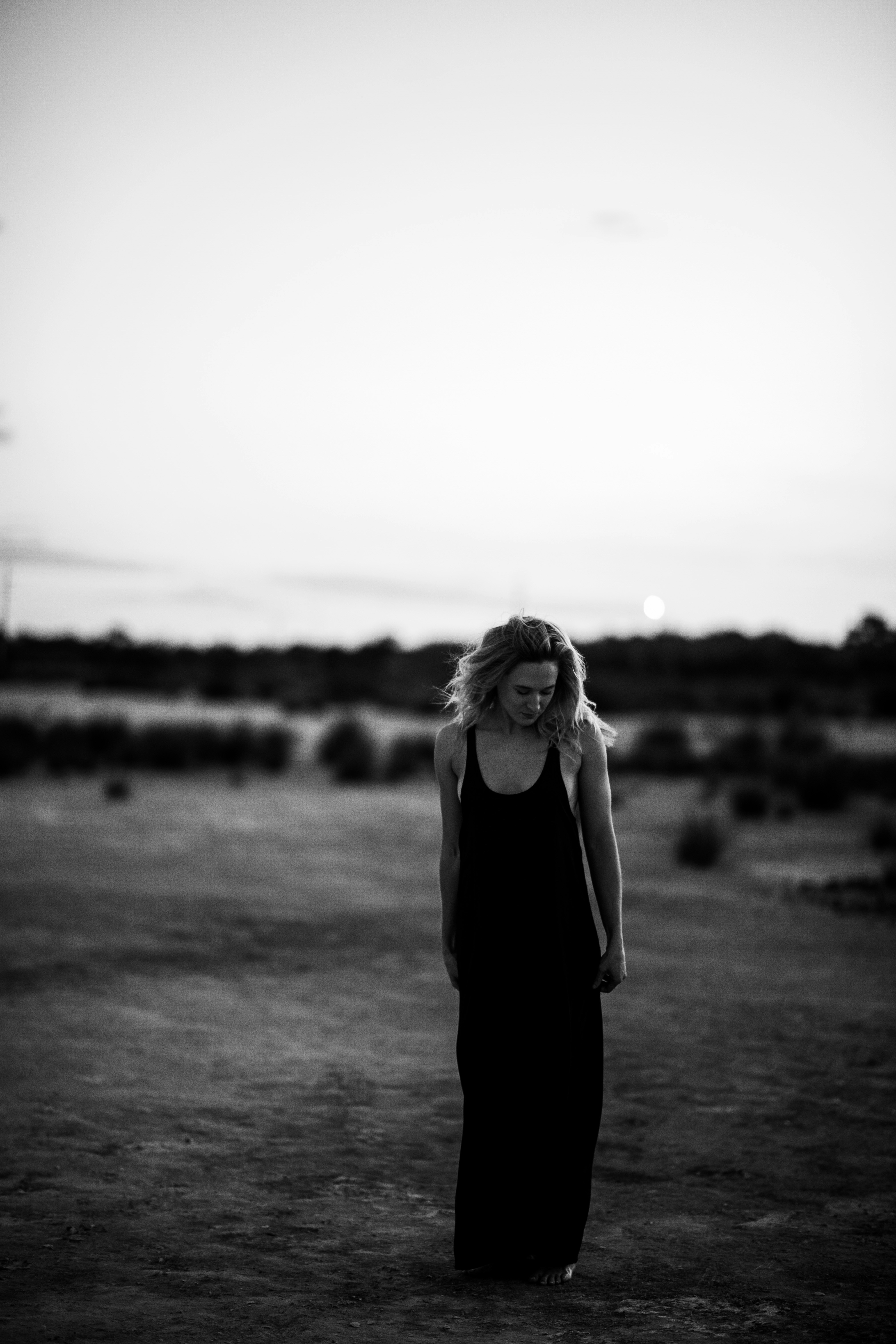 woman in black long sleeve shirt standing on field during daytime