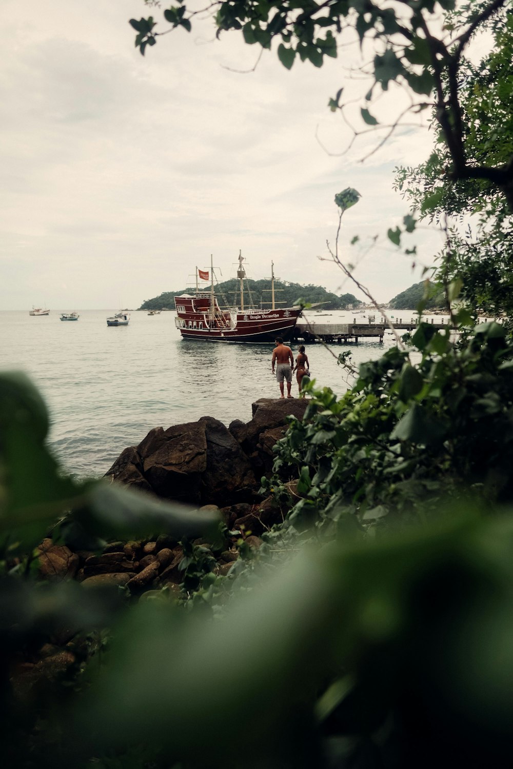 red and white boat on body of water during daytime