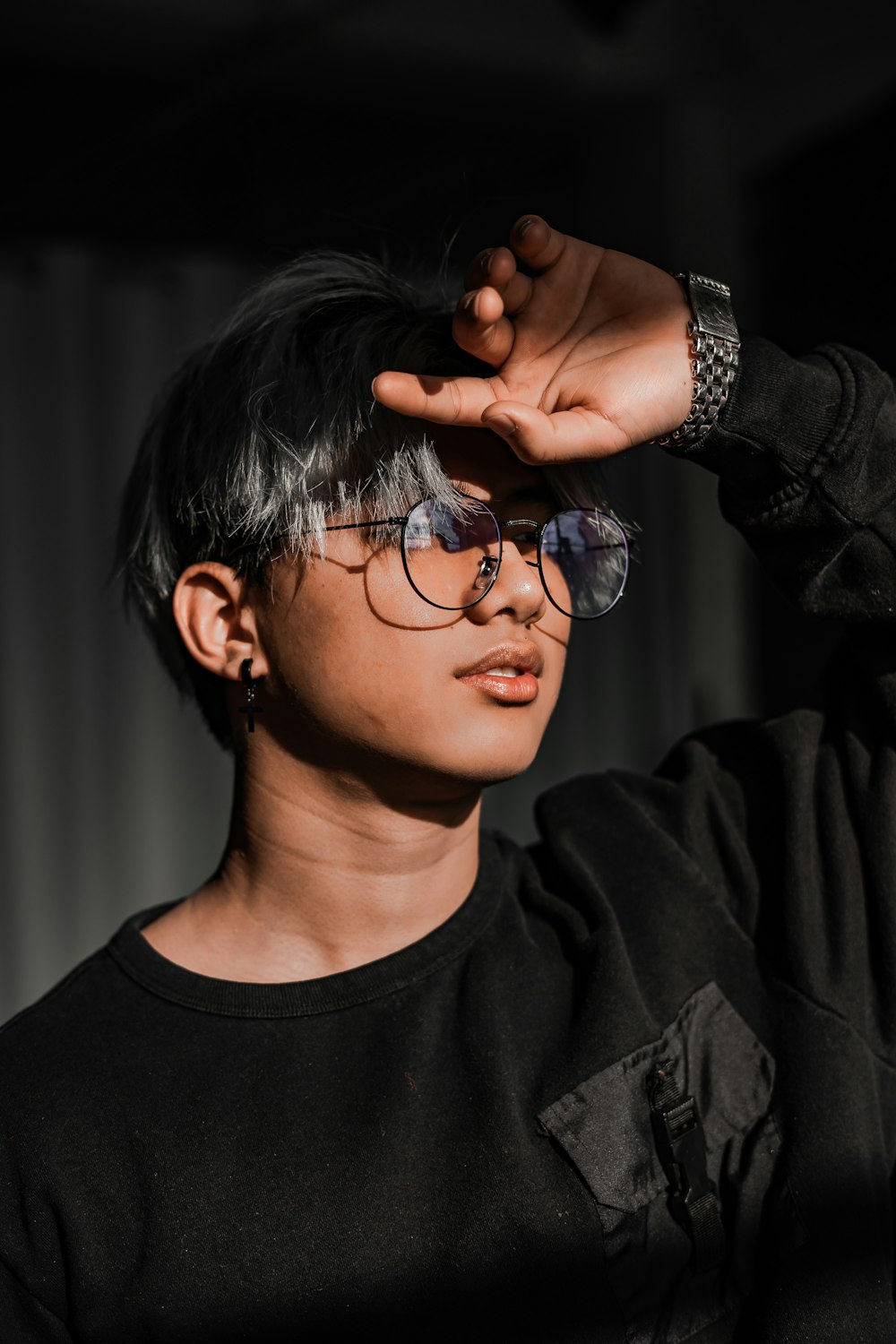 boy in black crew neck shirt wearing black framed eyeglasses