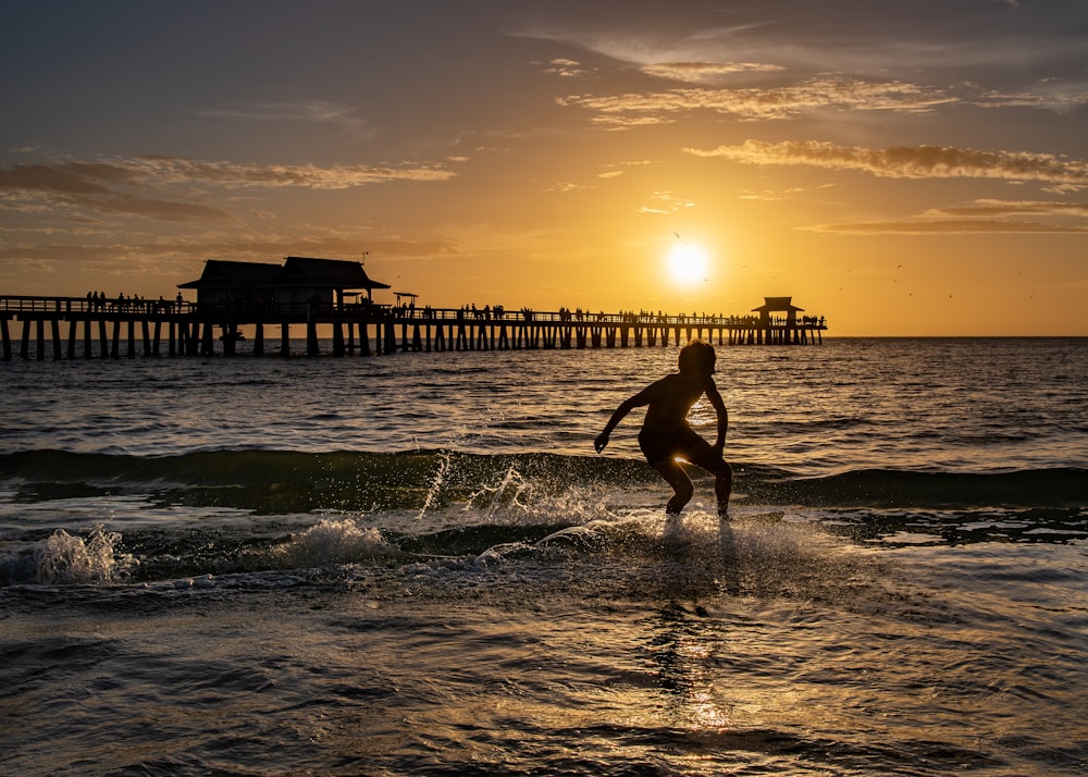 a person riding a surf board on a body of water