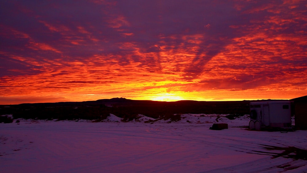 snow covered field during sunset