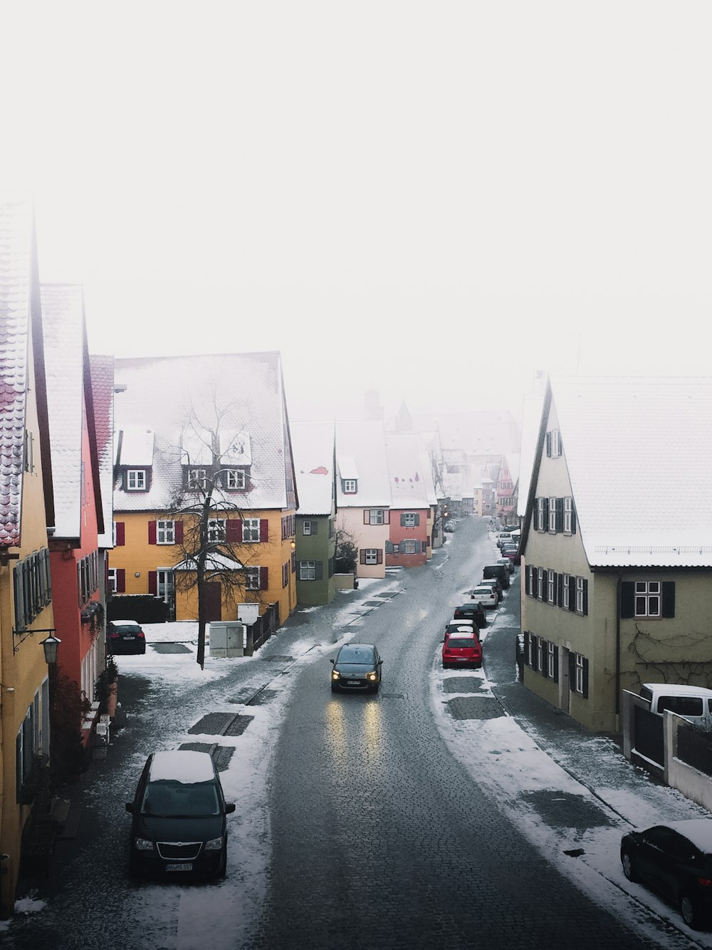 cars on road near buildings during daytime