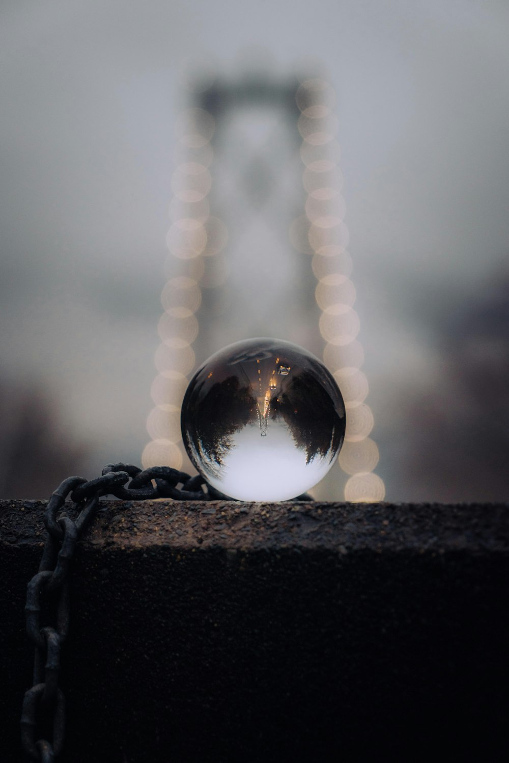 clear glass ball on brown wooden surface