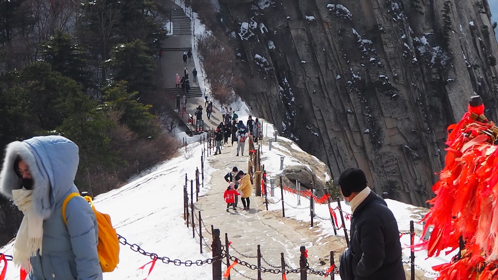 people walking on snow covered ground during daytime