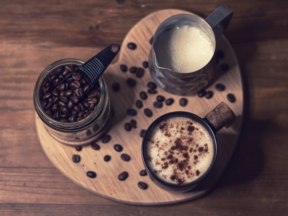 clear drinking glass with milk on brown wooden table