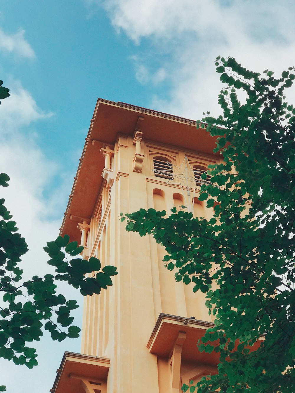 brown and white concrete building under blue sky during daytime