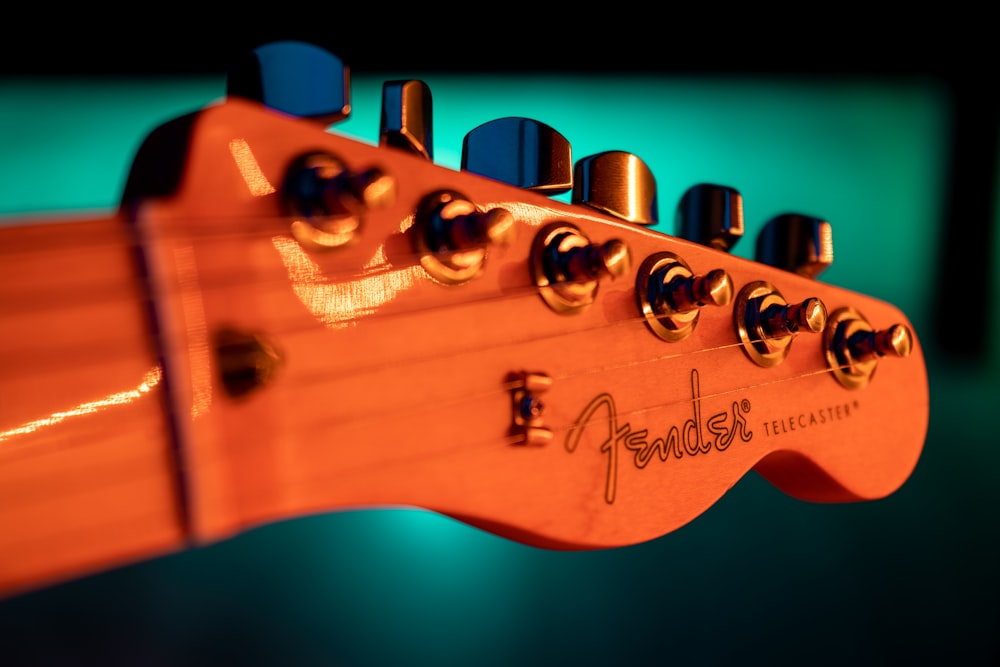 brown guitar headstock in close up photography