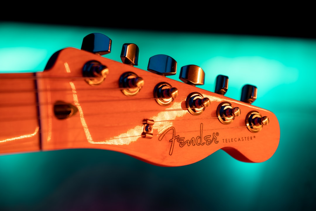 brown guitar headstock in close up photography