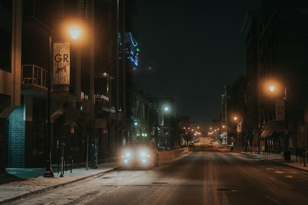 a car driving down a city street at night