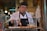 man in white chef uniform holding knife slicing meat