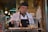 man in white chef uniform holding knife slicing meat