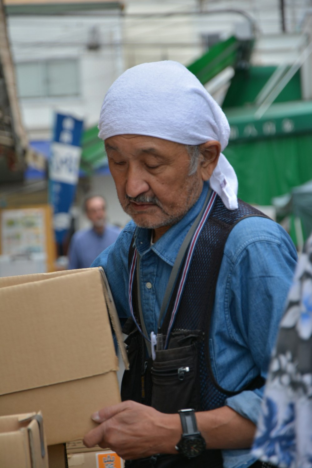 man in blue denim jacket wearing white knit cap