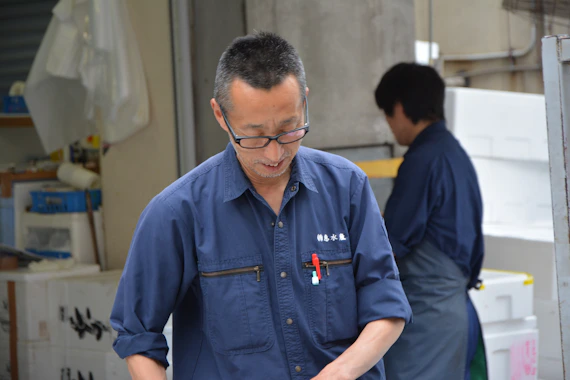 man in blue polo shirt wearing black framed eyeglasses