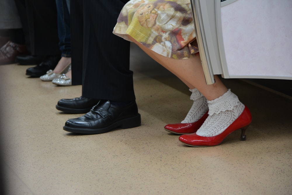 person in black pants and red and white socks