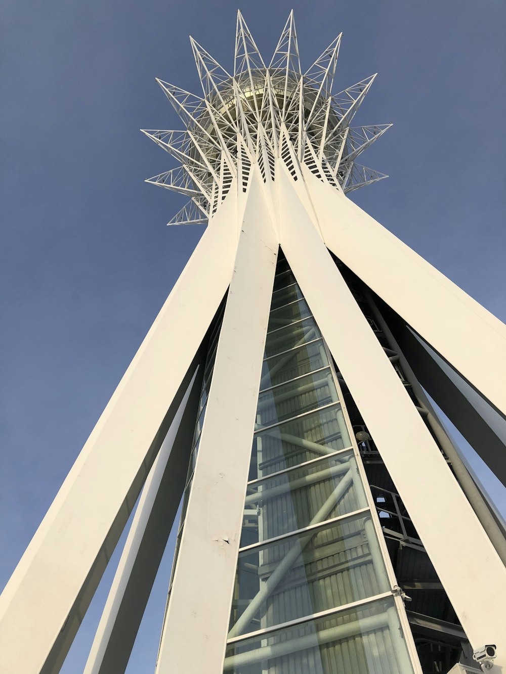 a tall white building with a sky background