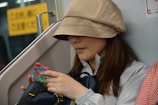 A woman using a smartphone app while waiting for public transport.