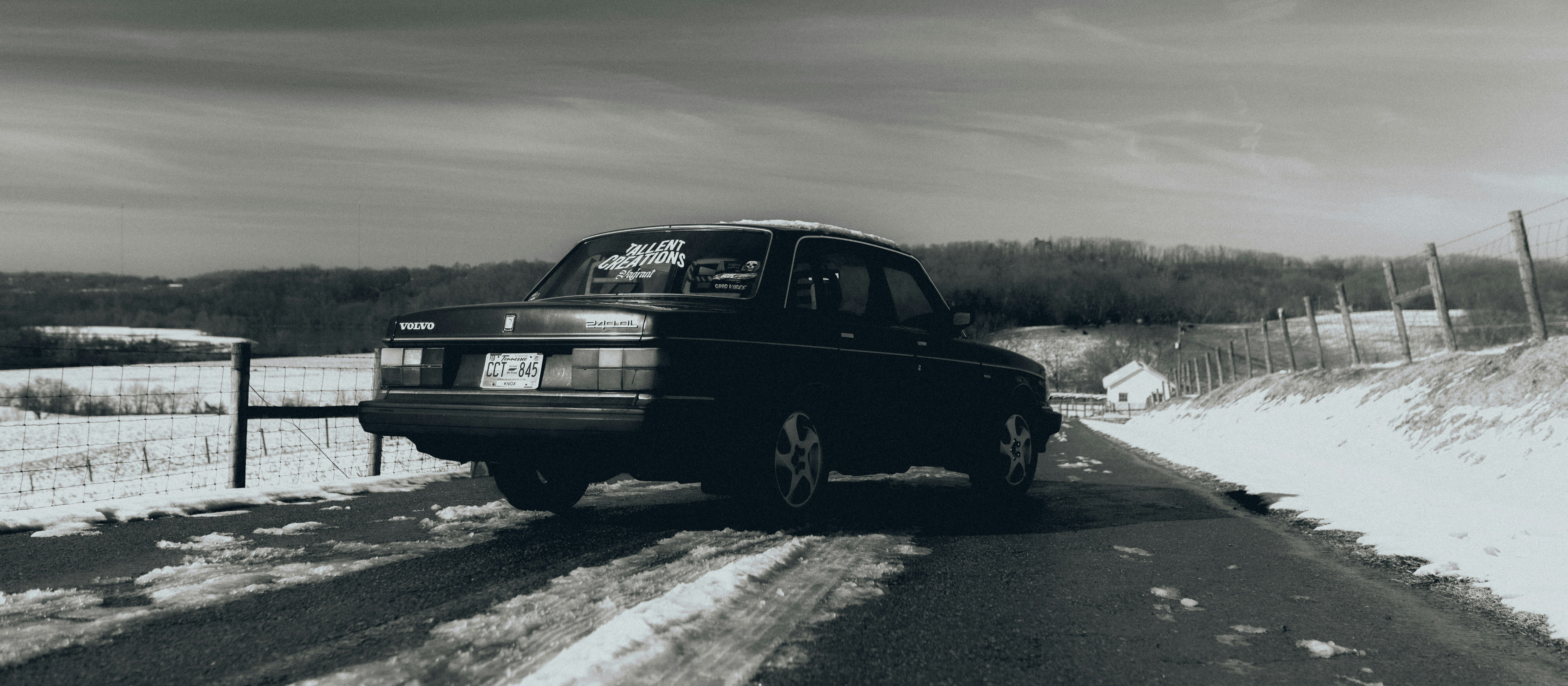 black suv on snow covered road during daytime