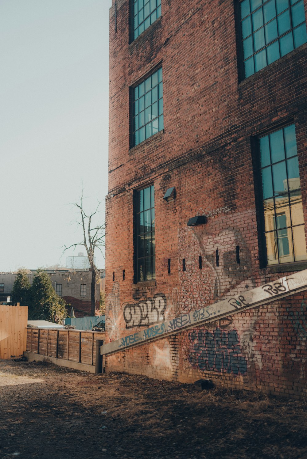 brown concrete building near bare trees during daytime