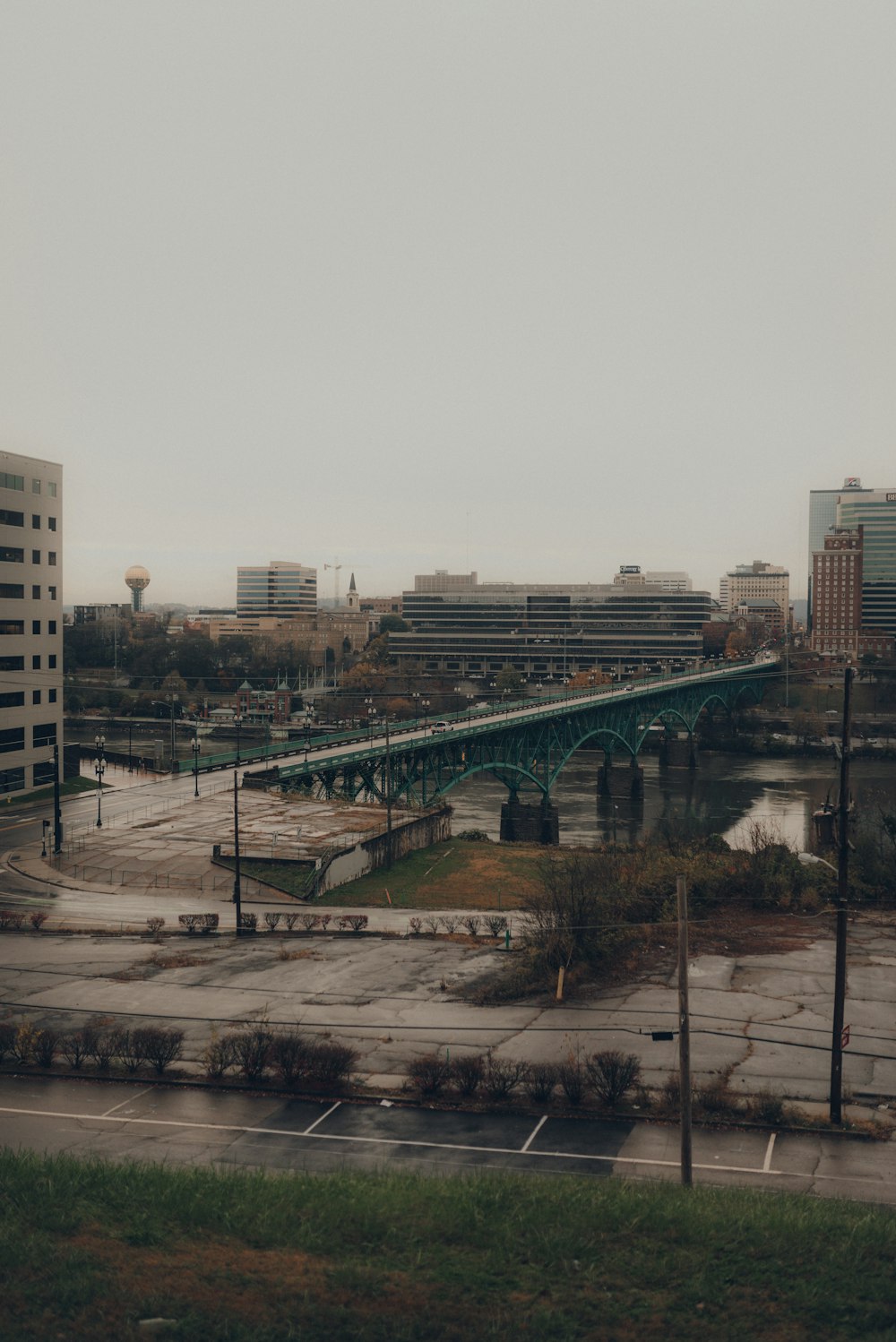 white and brown concrete building near bridge during daytime