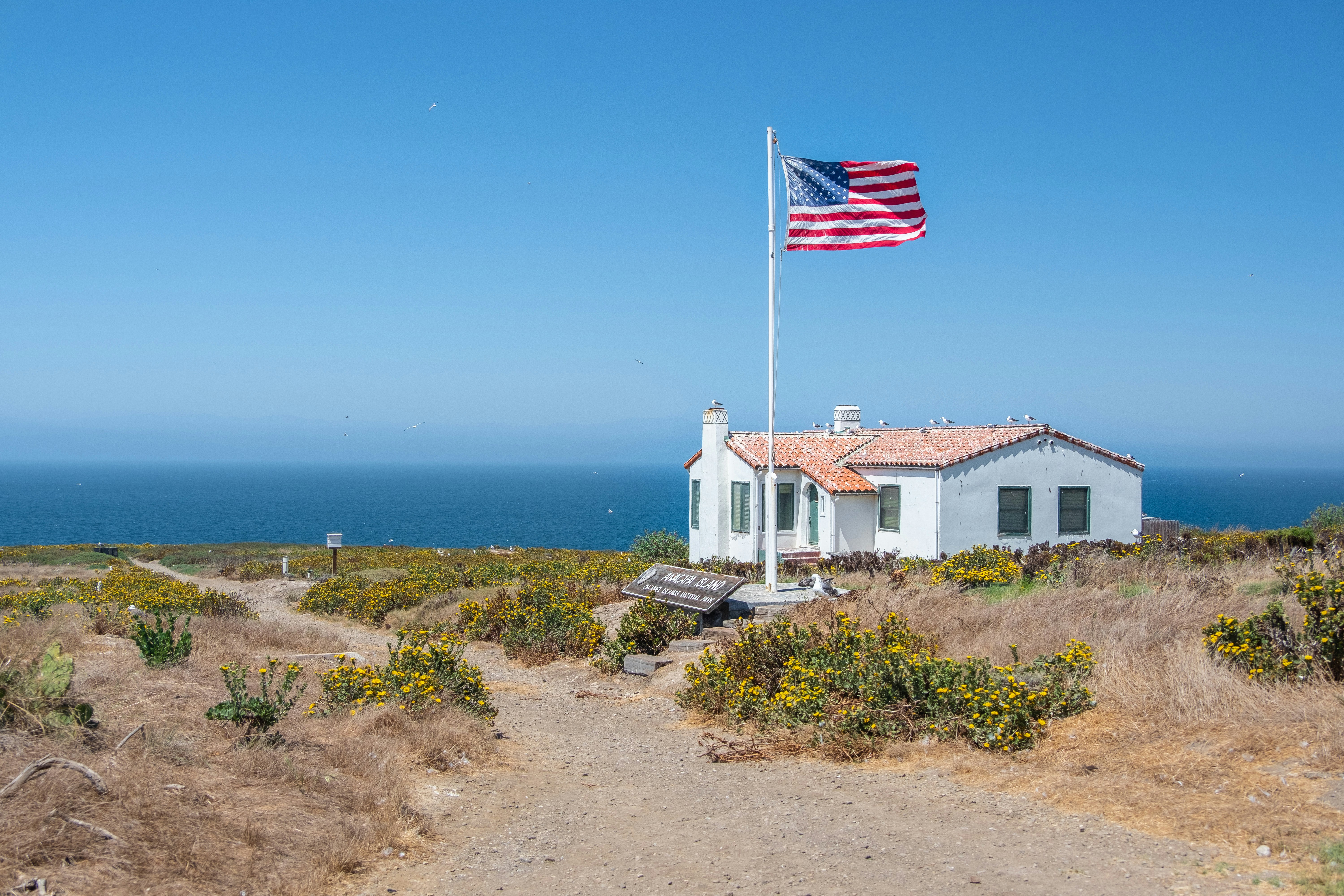 white concrete house near body of water during daytime