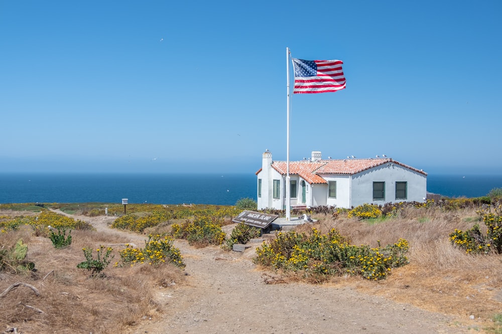 white concrete house near body of water during daytime