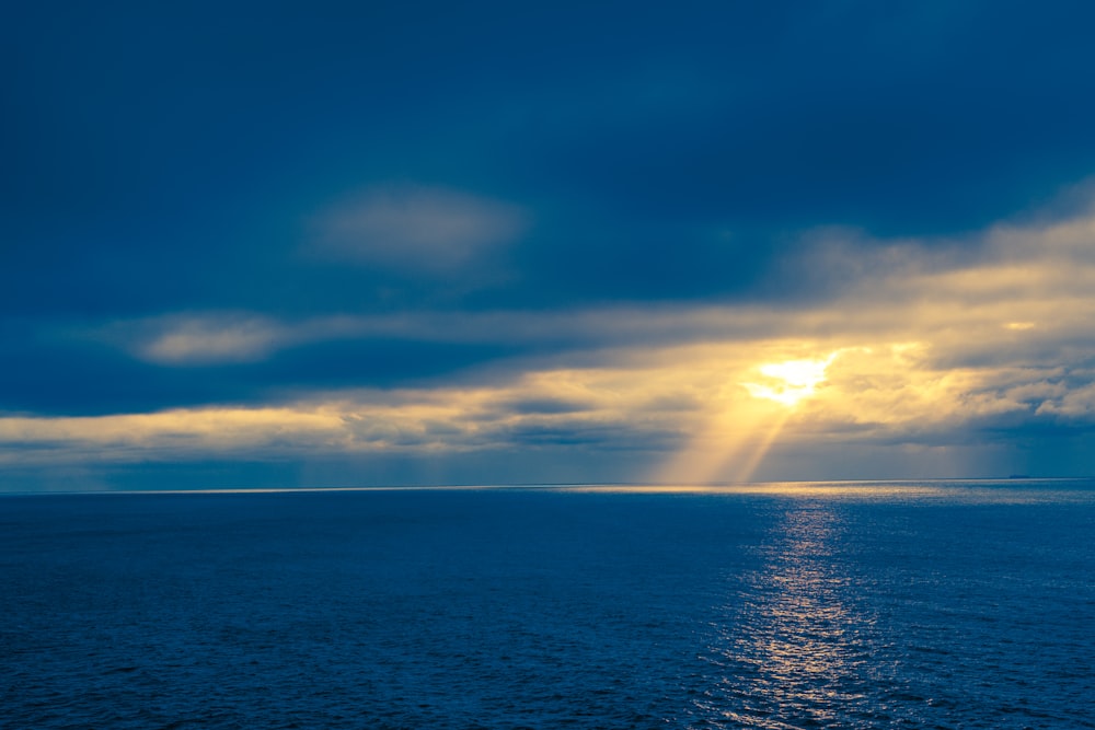 blue sea under blue sky and white clouds during daytime