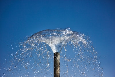 water splash on brown wooden stick