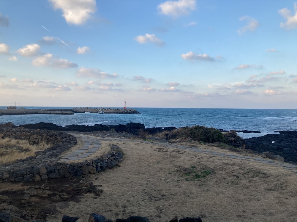 brown rocky shore under blue sky during daytime