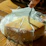 Close-up of a vacuum-packed costeño cheese on a rustic wooden table.