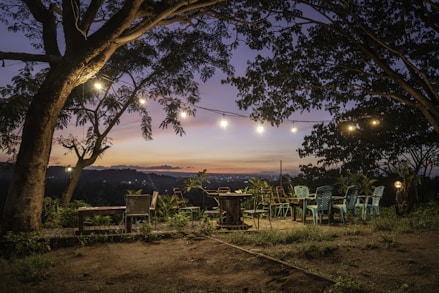 Outdoor patio with seating area and string lights at dusk
