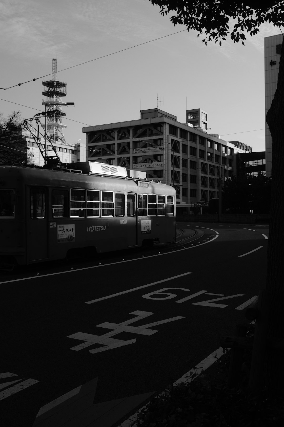 grayscale photo of tram on road