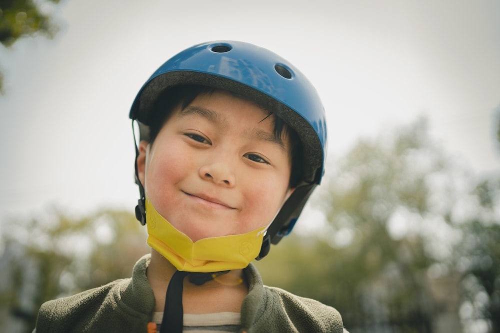 boy in blue helmet and gray hoodie