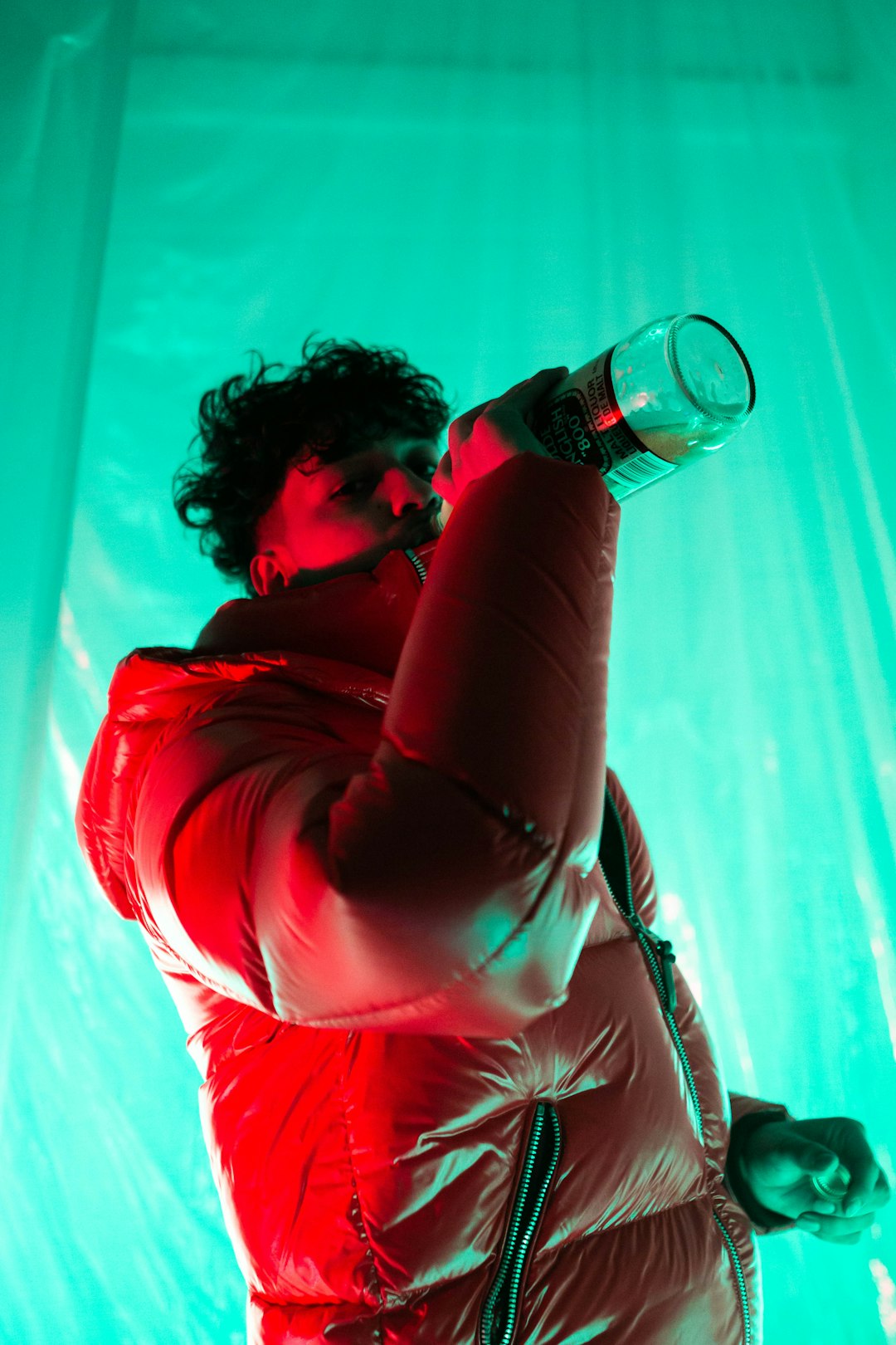 woman in red leather jacket drinking water