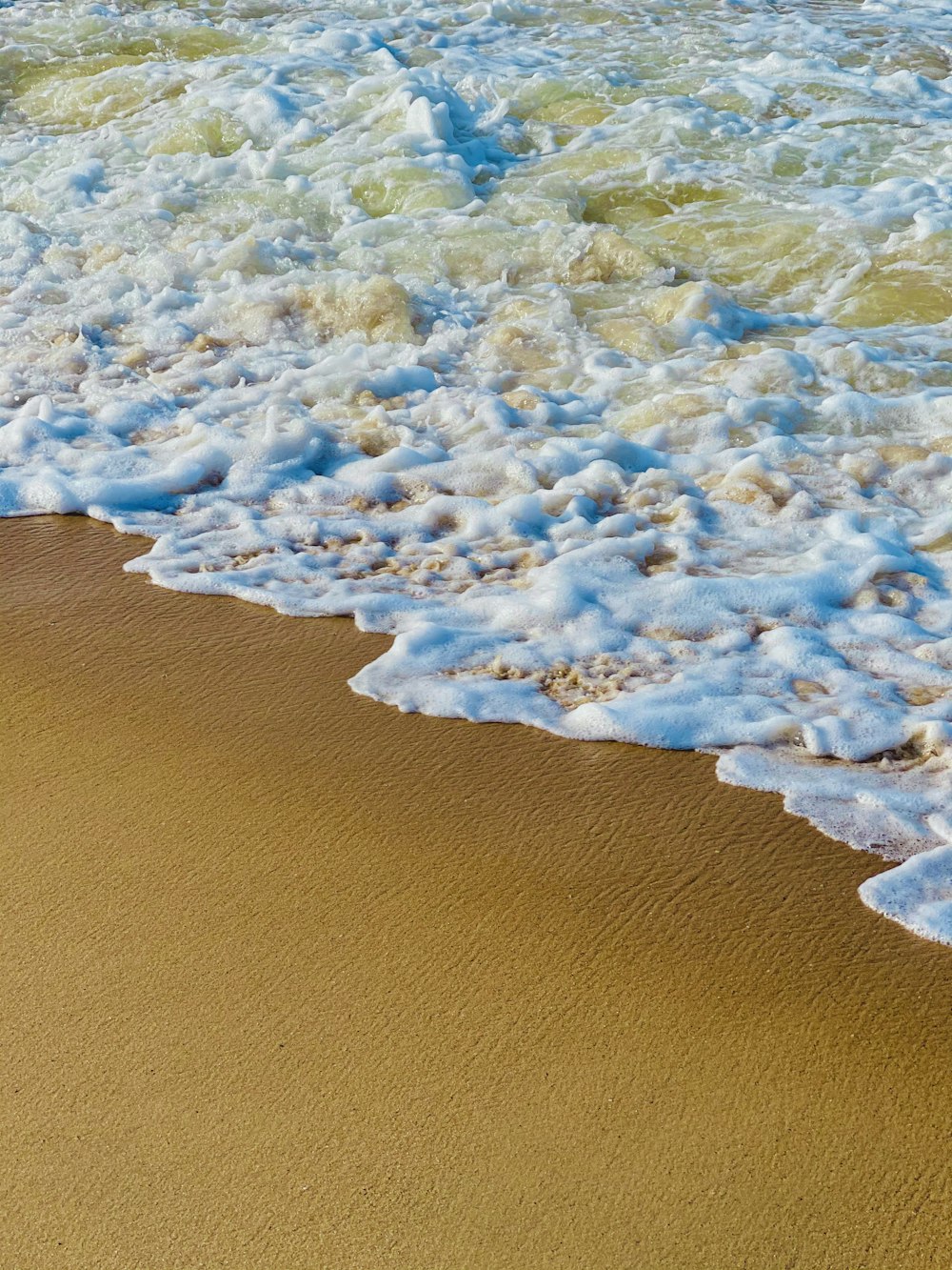 brown and white rock formation on body of water during daytime