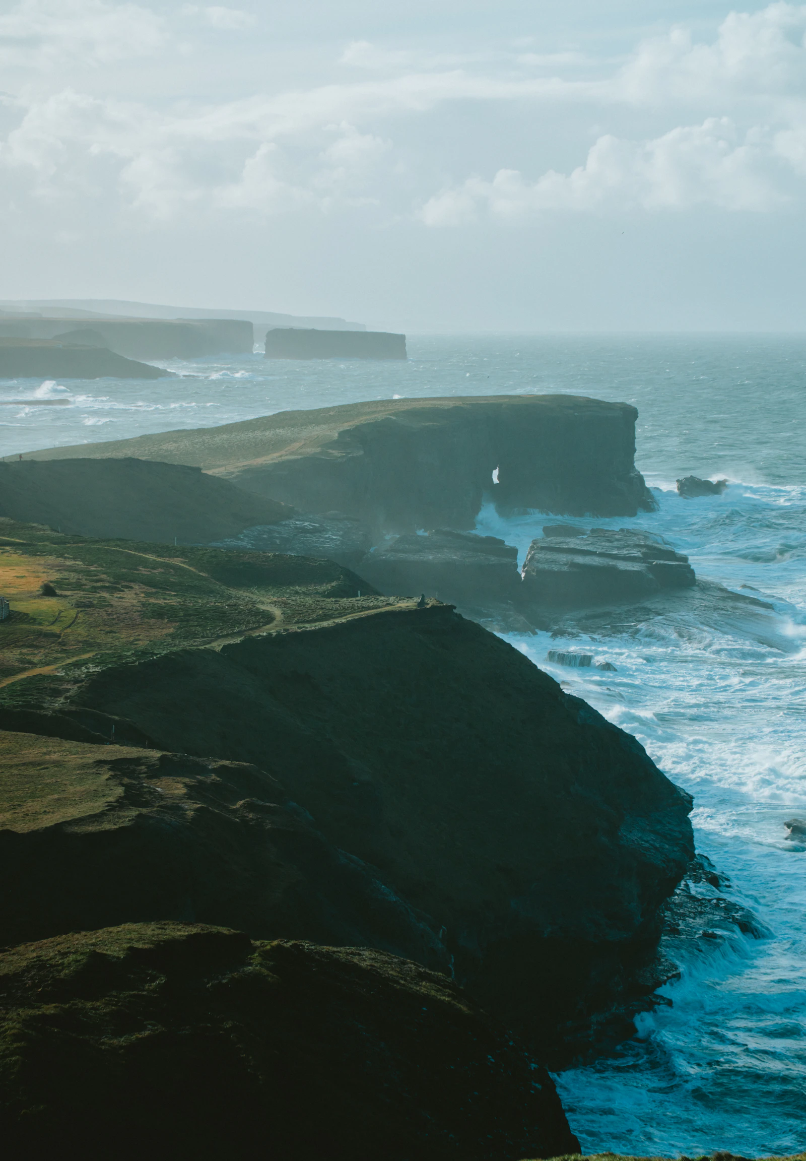 Dark Atlantic cliffs beneath shifting cloud on Ireland's west coast