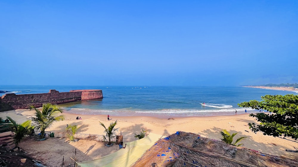 beach shore with blue ocean water under blue sky during daytime