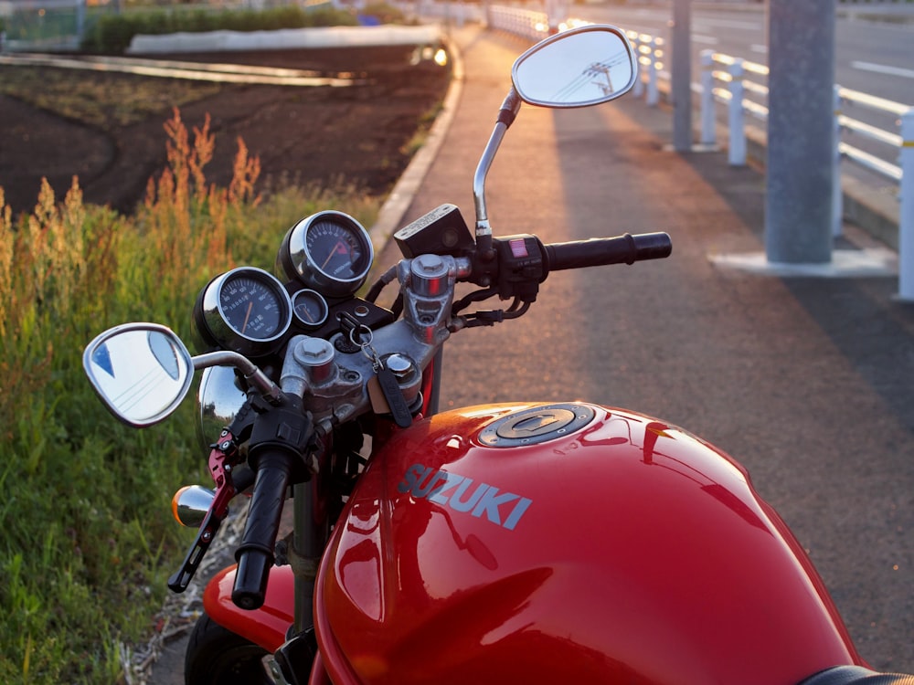 red and black motorcycle on road during daytime