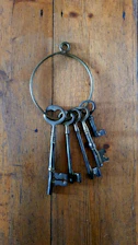silver skeleton keys on brown wooden table
