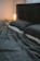 A warmly lit lodge room with a neatly made bed and soft pillows.