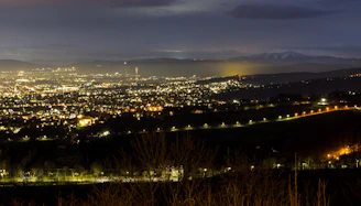 Night view of the illuminated cityscape of Lima with mountains in the background.