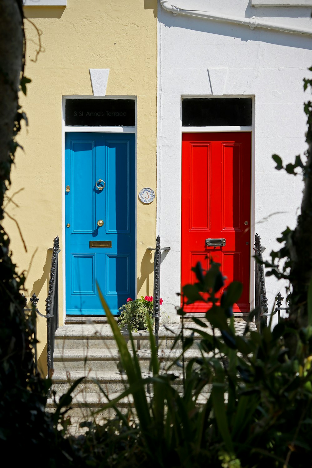 blue wooden door with red door