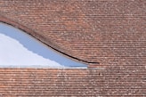 brown brick roof under blue sky during daytime