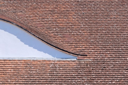 brown brick roof under blue sky during daytime