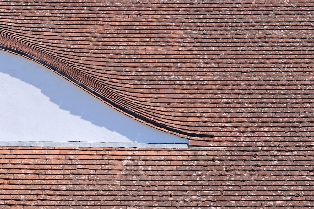 brown brick roof under blue sky during daytime