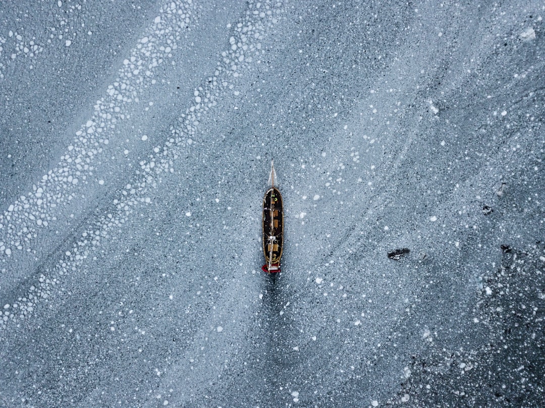 black and brown fishing rod on gray concrete floor,