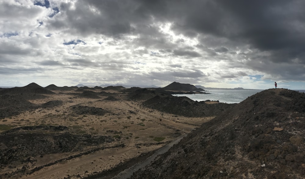 brown and green mountains under white clouds during daytime